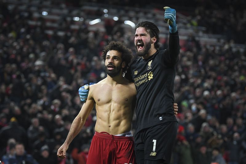 Alisson celebrating with Mo Salah after assisting the Egyptian for Liverpool's second goal against Man Utd